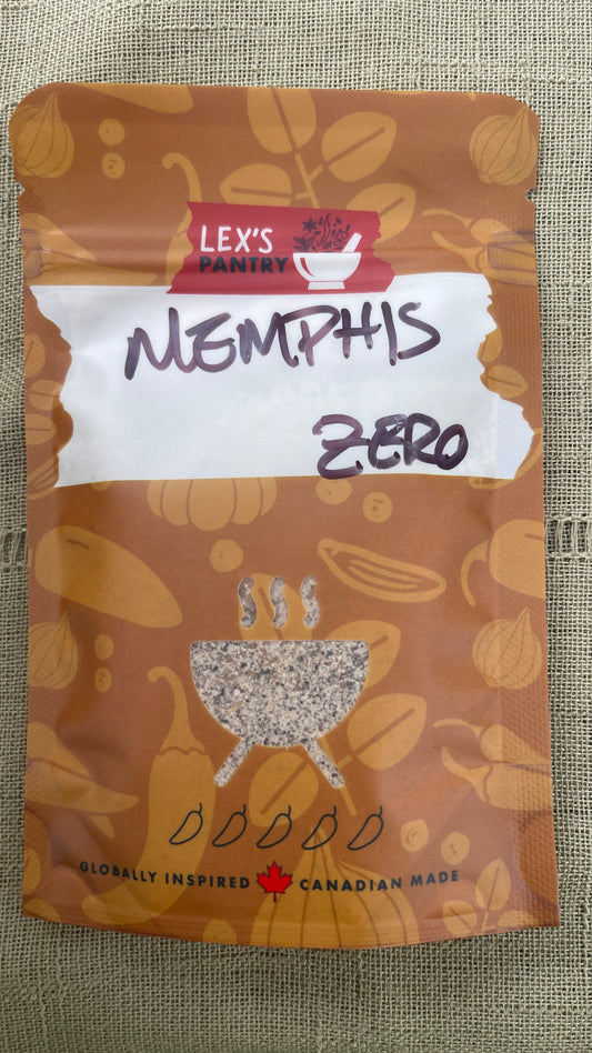 A stand-up pouch of Lex's Pantry Memphis Zero Wing Rub, featuring a kraft-brown spice-themed design with spices & herb illustrations, a white label area with handwritten "Memphis Zero" and a clear barbecue shaped window showing the mixed seasoning inside.