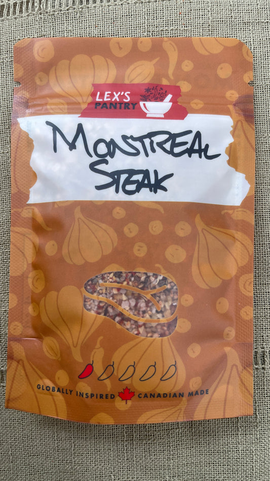 A stand-up pouch of Lex's Pantry Montreal Steak seasoning mix, featuring an kraft-brown patterned background with garlic bulb and peppercorn illustrations, a white label, and a clear window showing the seasoning inside.