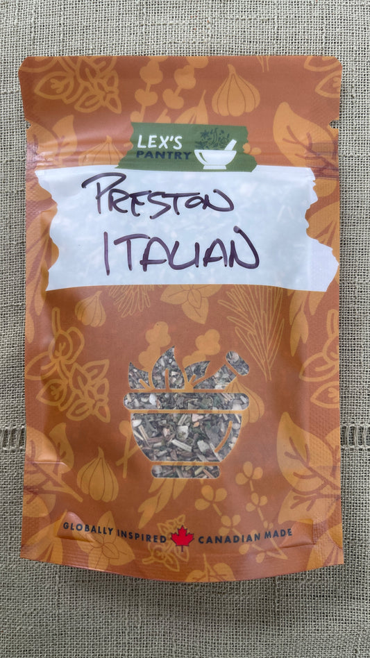 A resealable stand-up pouch of Preston St. Italian Seasoning from Lex's Pantry in an kraft-brown package with botanical leaf patterns, a white label, and a clear window showing the herbs and garlic inside.